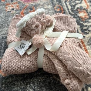 Blush color knit blanket and slipper bootie gift set.